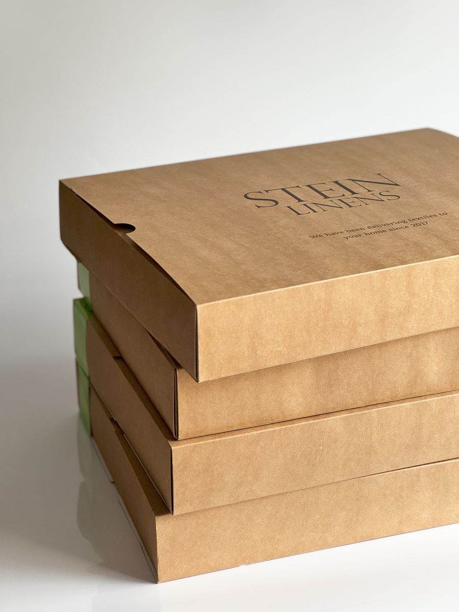 Stacked plain kraft cardboard mailer boxes