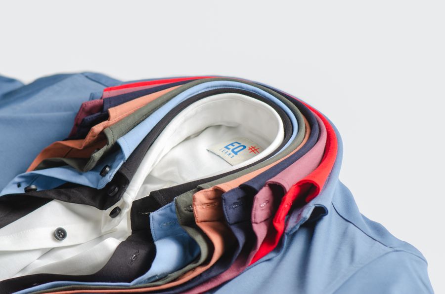 Stacked folded corporate polo shirts in assorted colours