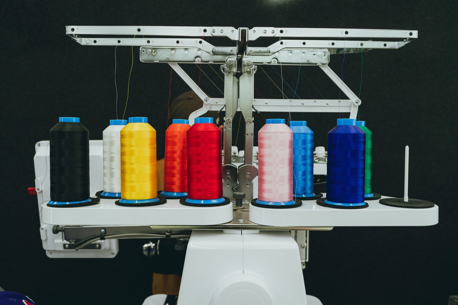 Thread spools loaded on an industrial embroidery machine