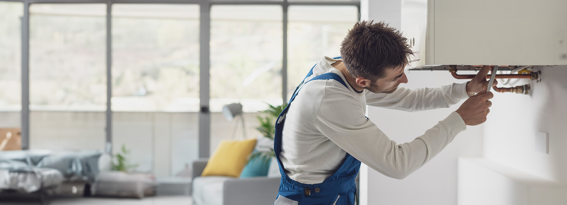 A heating engineer working on a domestic boiler